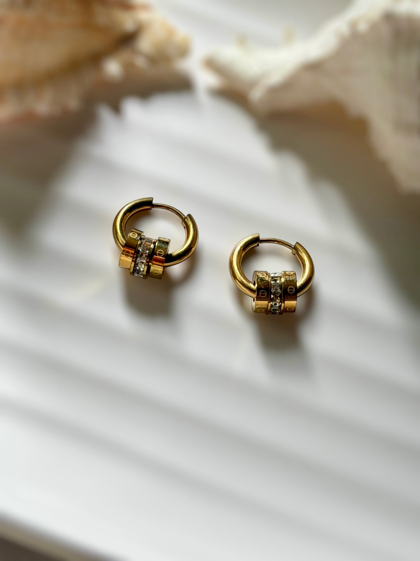 Tiered emblem earrings