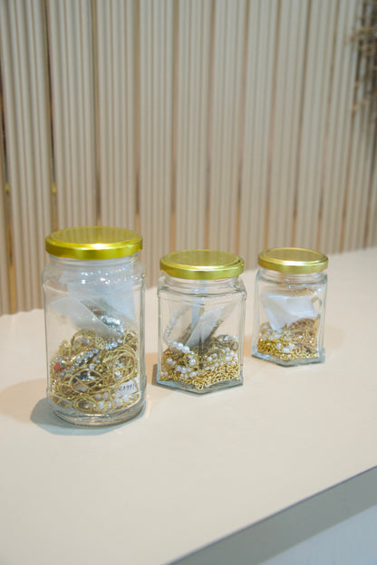 Esteva Mystery Jar jewellery pieces in jar